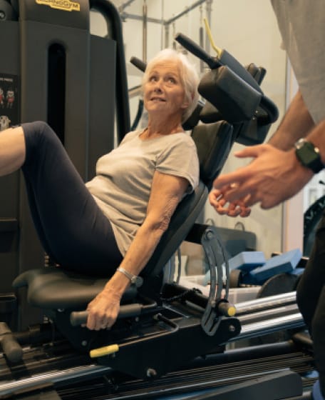woman smiling on gym equipment
