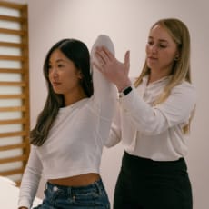 a clinician stretching a clients elbow up